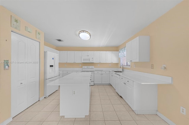 21343 SW 88th Ct, Cutler Bay, FL 33189 - kitchen featuring white appliances, light countertops, a kitchen island, and white cabinetry