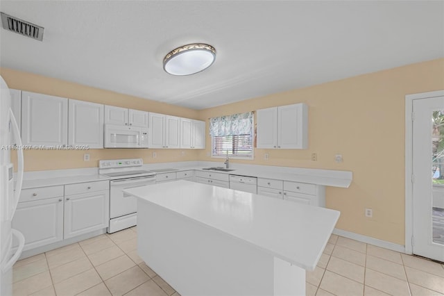 21343 SW 88th Ct, Cutler Bay, FL 33189 - kitchen featuring white appliances, light tile patterned floors, light countertops, white cabinetry, and a center island