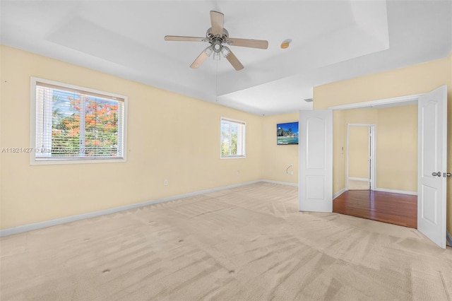 21343 SW 88th Ct, Cutler Bay, FL 33189 - unfurnished bedroom with light carpet, a raised ceiling, and ceiling fan