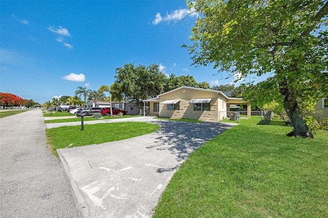 6428 Plunkett St, Hollywood, FL 33023 - ranch-style home with a front yard and curved driveway