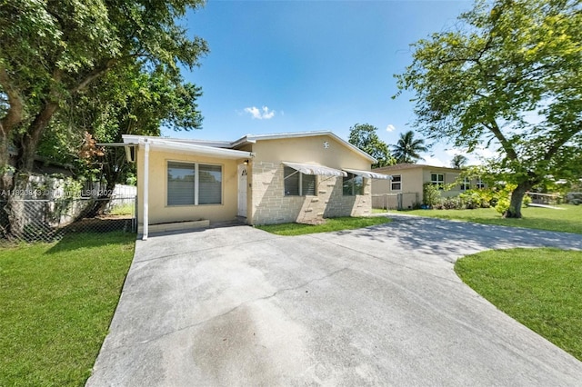 6428 Plunkett St, Hollywood, FL 33023 - view of front facade featuring concrete driveway and stucco siding
