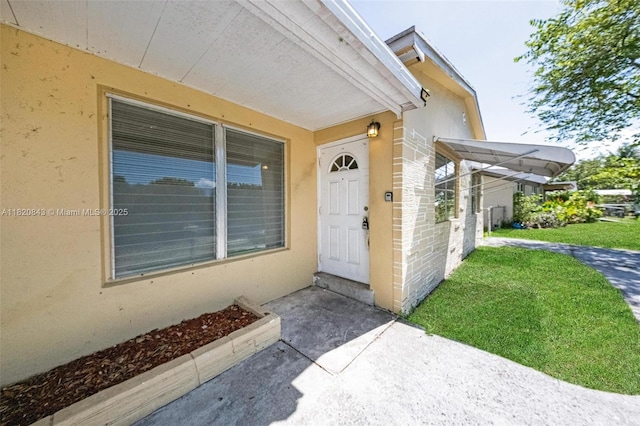 6428 Plunkett St, Hollywood, FL 33023 - doorway to property with a yard and stucco siding