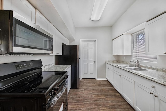 6428 Plunkett St, Hollywood, FL 33023 - kitchen with electric range, stainless steel microwave, dark wood-style floors, and white cabinets