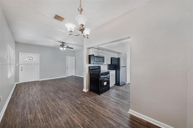 6428 Plunkett St, Hollywood, FL 33023 - kitchen with appliances with stainless steel finishes, a chandelier, dark wood finished floors, a ceiling fan, and white cabinets