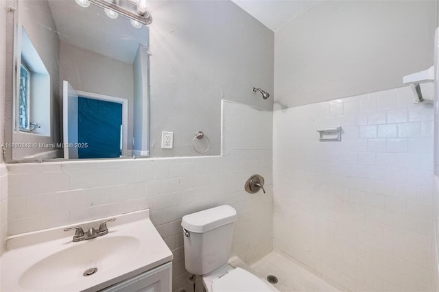6428 Plunkett St, Hollywood, FL 33023 - bathroom featuring tiled shower, tile walls, vanity, and wainscoting