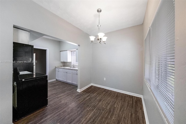 6428 Plunkett St, Hollywood, FL 33023 - kitchen with dark wood-style floors, white cabinetry, a chandelier, hanging light fixtures, and light countertops