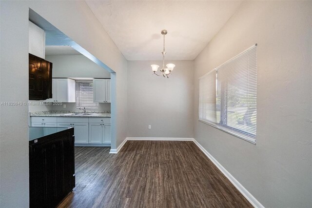 6428 Plunkett St, Hollywood, FL 33023 - kitchen featuring dark wood-type flooring, white cabinetry, a chandelier, pendant lighting, and light countertops