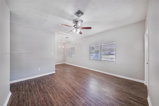 6428 Plunkett St, Hollywood, FL 33023 - empty room featuring ceiling fan, dark wood finished floors, and a chandelier