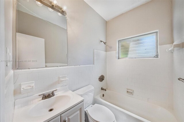 6428 Plunkett St, Hollywood, FL 33023 - full bath with vanity, tile walls, shower / bath combination, and a wainscoted wall