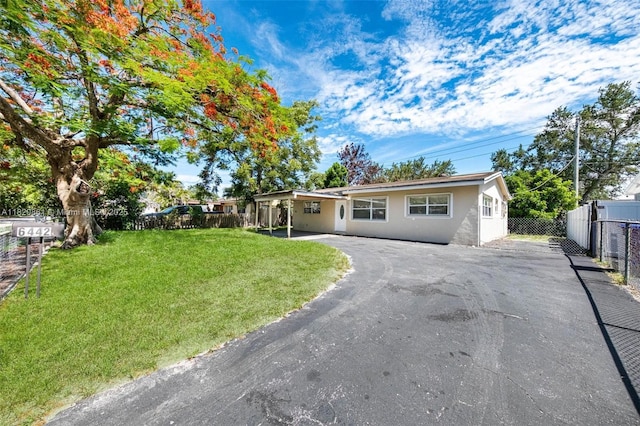 6442 Oak St, Hollywood, FL 33024 - ranch-style home featuring asphalt driveway, stucco siding, and a patio