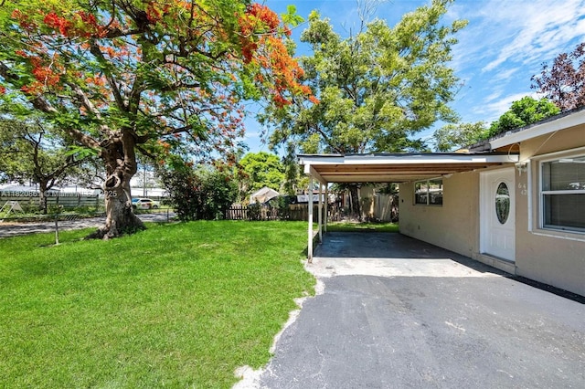 6442 Oak St, Hollywood, FL 33024 - view of yard with an attached carport and asphalt driveway