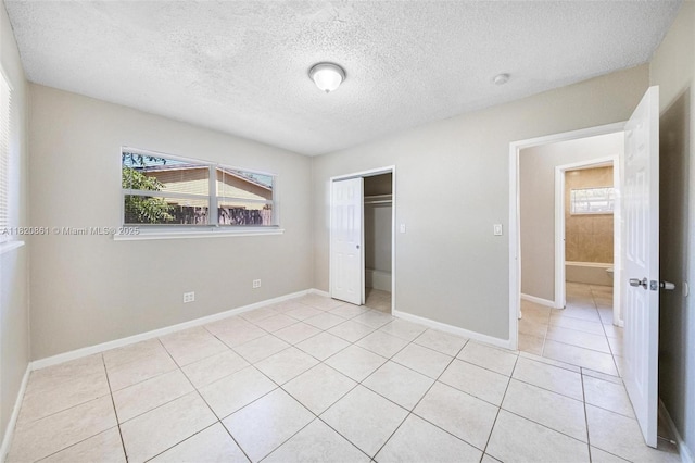 6442 Oak St, Hollywood, FL 33024 - unfurnished bedroom featuring light tile patterned flooring, a closet, and a textured ceiling