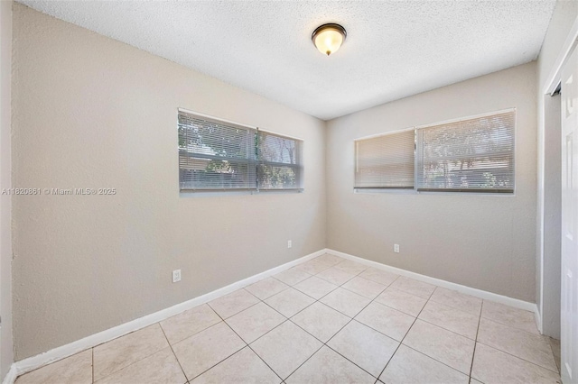 6442 Oak St, Hollywood, FL 33024 - empty room with plenty of natural light, light tile patterned floors, and a textured ceiling