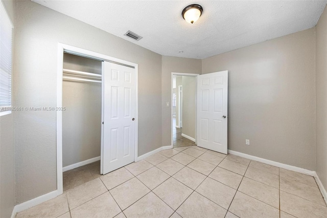6442 Oak St, Hollywood, FL 33024 - unfurnished bedroom with light tile patterned floors, a closet, and a textured ceiling