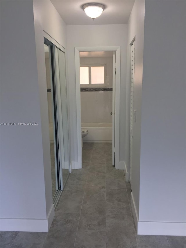 7840 Camino Real Unit P312, Miami, FL 33143 - corridor with tile patterned floors and baseboards
