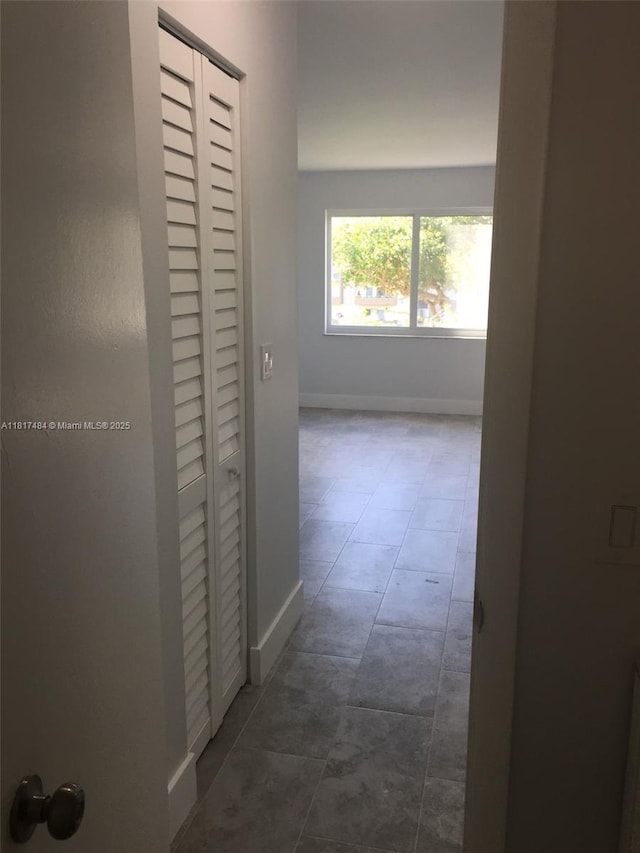 7840 Camino Real Unit P312, Miami, FL 33143 - corridor with baseboards and dark tile patterned floors