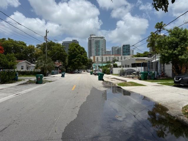 67 NW 34th St, Miami, FL 33127 - view of asphalt road featuring sidewalks and a view of city