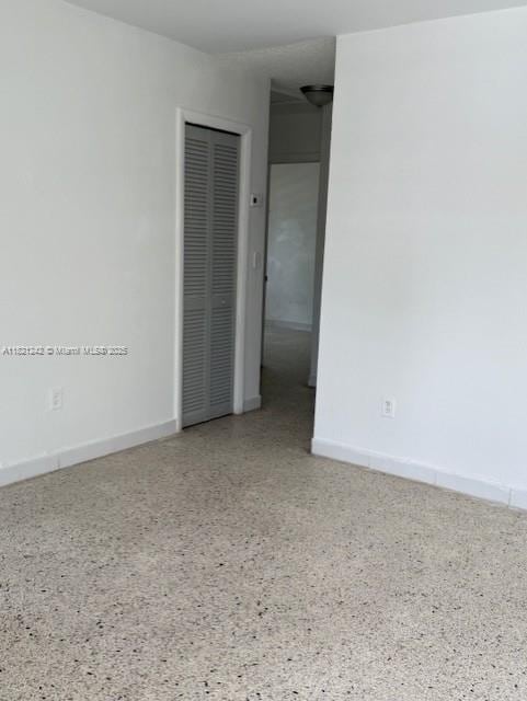 67 NW 34th St, Miami, FL 33127 - unfurnished room with speckle patterned floor and baseboards