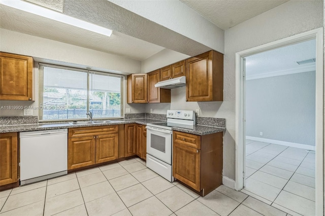 4818 NW 8th St, Plantation, FL 33317 - kitchen with white appliances, under cabinet range hood, brown cabinets, a textured ceiling, and light tile patterned floors