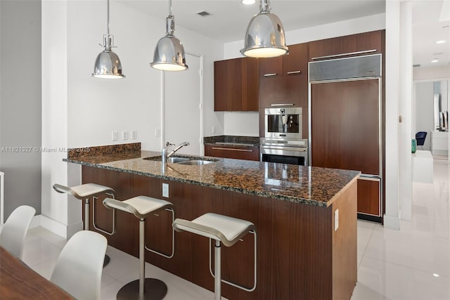 15901 Collins Ave Unit 3302, Sunny Isles Beach, FL 33160 - kitchen featuring paneled built in refrigerator, light tile patterned floors, modern cabinets, a peninsula, and stainless steel double oven