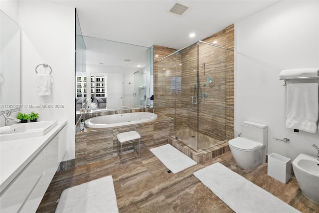 15901 Collins Ave Unit 3302, Sunny Isles Beach, FL 33160 - bathroom featuring a bidet, a garden tub, a stall shower, double vanity, and recessed lighting