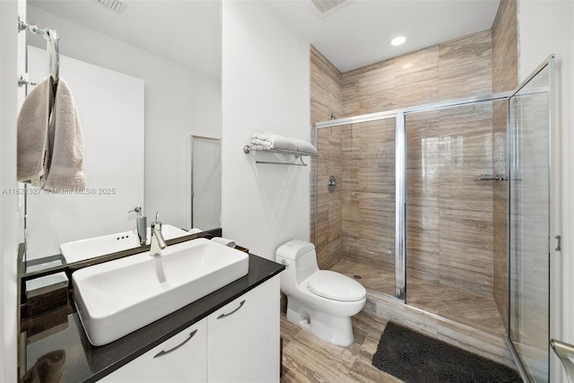 15901 Collins Ave Unit 3302, Sunny Isles Beach, FL 33160 - bathroom with vanity, a shower stall, and wood finished floors