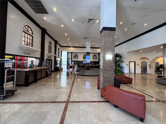 19201 N Collins Ave Unit 826, Sunny Isles Beach, FL 33160 - community lobby with ornamental molding, recessed lighting, and a towering ceiling