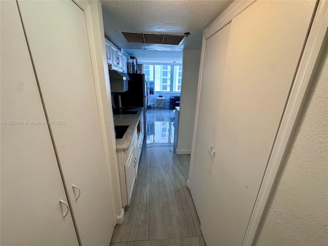 19201 N Collins Ave Unit 826, Sunny Isles Beach, FL 33160 - hallway with a textured ceiling and wood finished floors