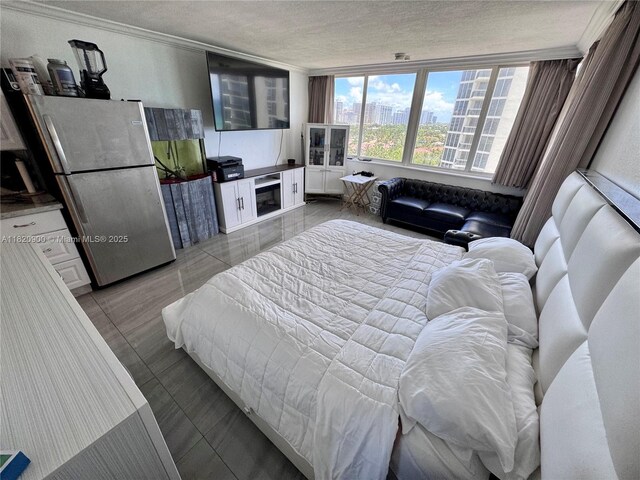19201 N Collins Ave Unit 826, Sunny Isles Beach, FL 33160 - bedroom featuring freestanding refrigerator, a textured ceiling, and ornamental molding