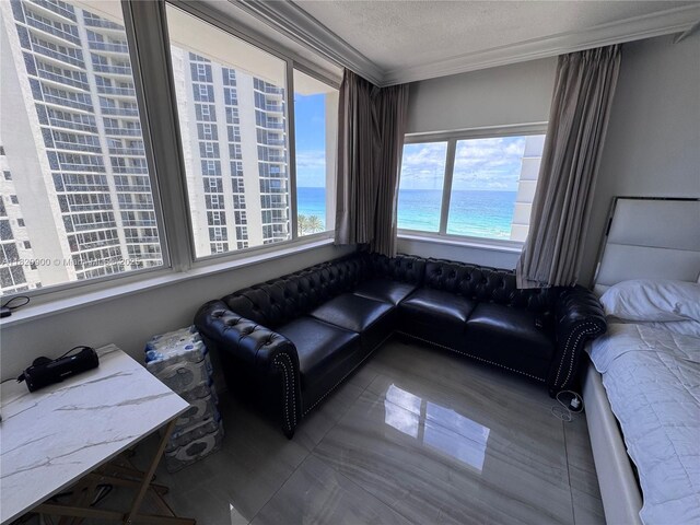 19201 N Collins Ave Unit 826, Sunny Isles Beach, FL 33160 - living room featuring crown molding, a textured ceiling, and a water view
