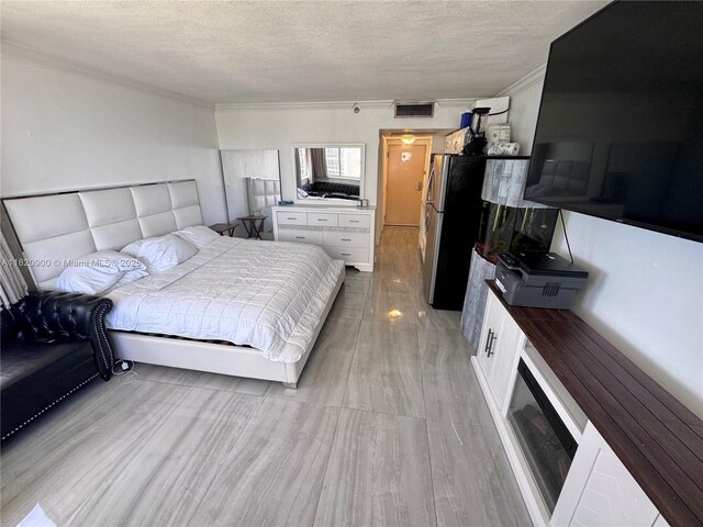 19201 N Collins Ave Unit 826, Sunny Isles Beach, FL 33160 - bedroom featuring ornamental molding, a textured ceiling, and light wood-style flooring