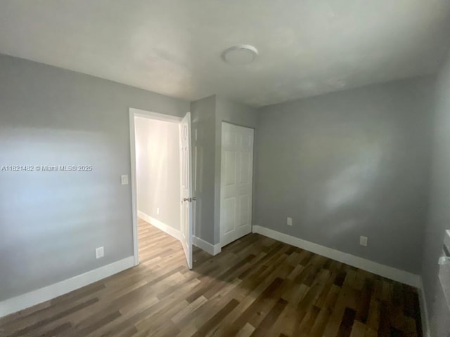 345 NE 168th St, North Miami Beach, FL 33162 - unfurnished bedroom with wood finished floors and baseboards