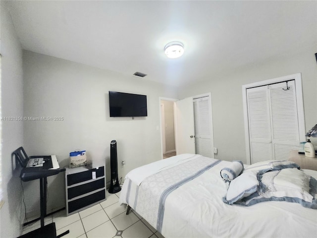3082 NW 4th St, Miami, FL 33125 - bedroom featuring two closets and light tile patterned floors