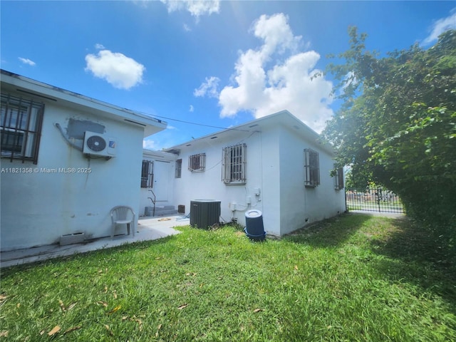 3082 NW 4th St, Miami, FL 33125 - back of house with a wall unit AC and stucco siding