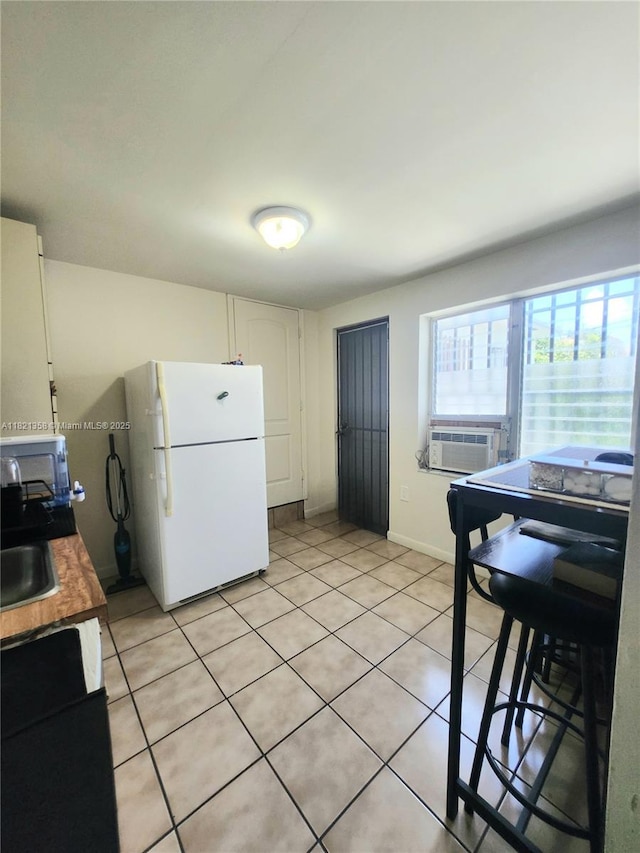 3082 NW 4th St, Miami, FL 33125 - kitchen with white appliances, cooling unit, light tile patterned floors, and healthy amount of natural light