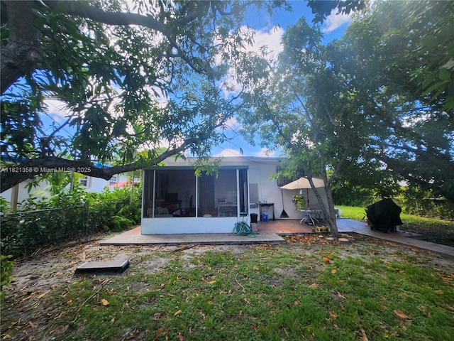 3082 NW 4th St, Miami, FL 33125 - rear view of property with a sunroom and a patio area