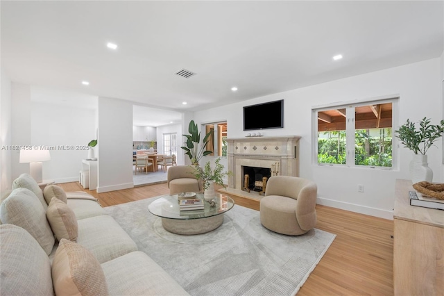 5211 Granada Blvd, Coral Gables, FL 33146 - living area with plenty of natural light, a fireplace, recessed lighting, and light wood-style flooring