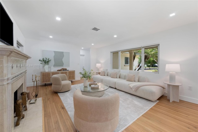 5211 Granada Blvd, Coral Gables, FL 33146 - living area with light wood-style floors, a premium fireplace, and recessed lighting
