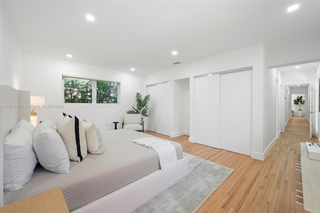 5211 Granada Blvd, Coral Gables, FL 33146 - bedroom featuring multiple closets, light wood-type flooring, and recessed lighting
