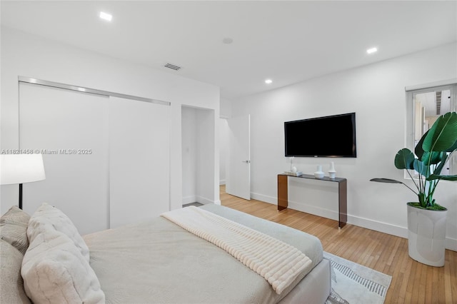 5211 Granada Blvd, Coral Gables, FL 33146 - bedroom with hardwood / wood-style flooring, recessed lighting, and a closet