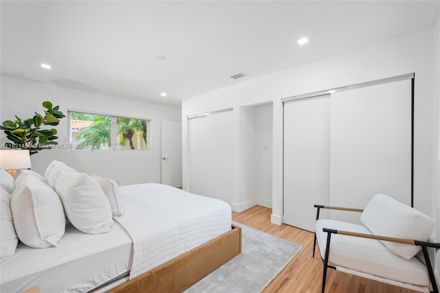 5211 Granada Blvd, Coral Gables, FL 33146 - bedroom with two closets, light wood-type flooring, and recessed lighting