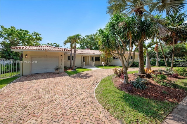 5211 Granada Blvd, Coral Gables, FL 33146 - view of front of home with decorative driveway, stucco siding, an attached garage, and a tile roof