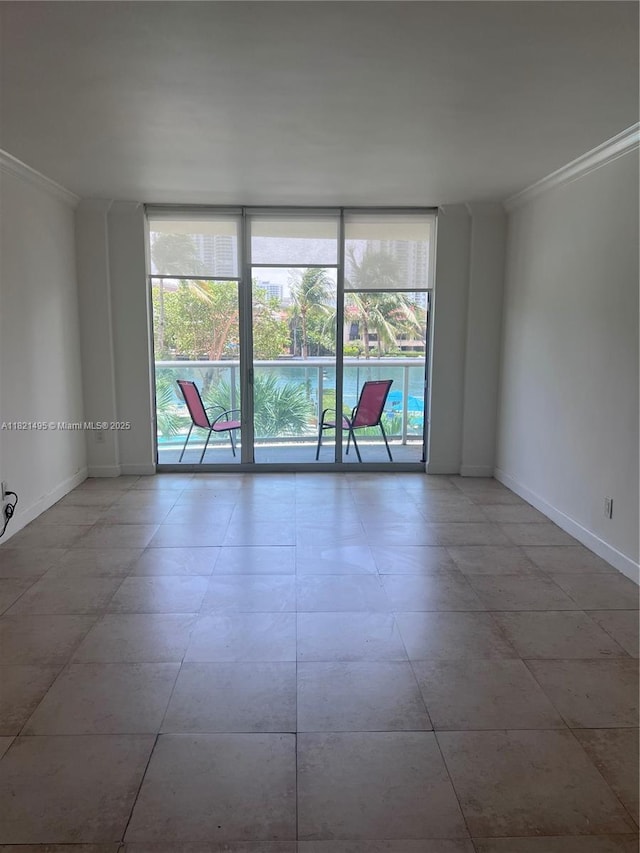 19390 Collins Ave Unit 207, Sunny Isles Beach, FL 33160 - empty room featuring ornamental molding and a wall of windows