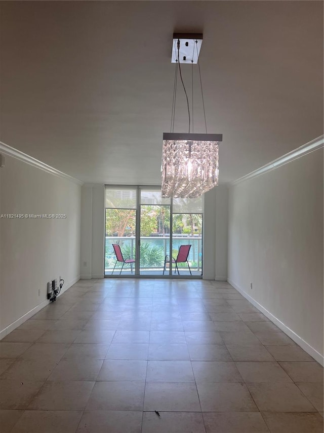 19390 Collins Ave Unit 207, Sunny Isles Beach, FL 33160 - tiled empty room with ornamental molding, a chandelier, and a wall of windows