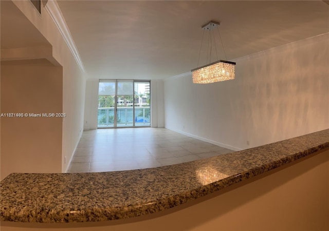 19390 Collins Ave Unit 207, Sunny Isles Beach, FL 33160 - unfurnished dining area featuring expansive windows, crown molding, and a chandelier