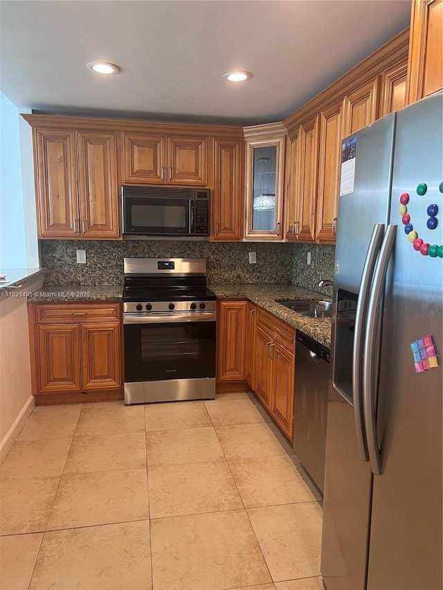 19390 Collins Ave Unit 207, Sunny Isles Beach, FL 33160 - kitchen featuring appliances with stainless steel finishes, brown cabinetry, backsplash, glass insert cabinets, and recessed lighting