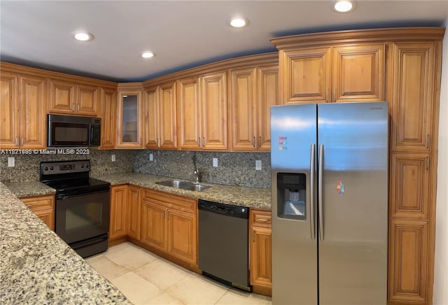 19390 Collins Ave Unit 207, Sunny Isles Beach, FL 33160 - kitchen featuring black appliances, tasteful backsplash, light stone counters, brown cabinetry, and recessed lighting