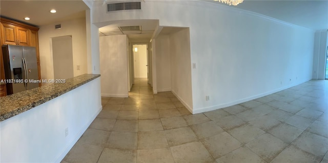 19390 Collins Ave Unit 207, Sunny Isles Beach, FL 33160 - kitchen with stainless steel fridge with ice dispenser, dark stone countertops, brown cabinetry, recessed lighting, and light tile patterned floors