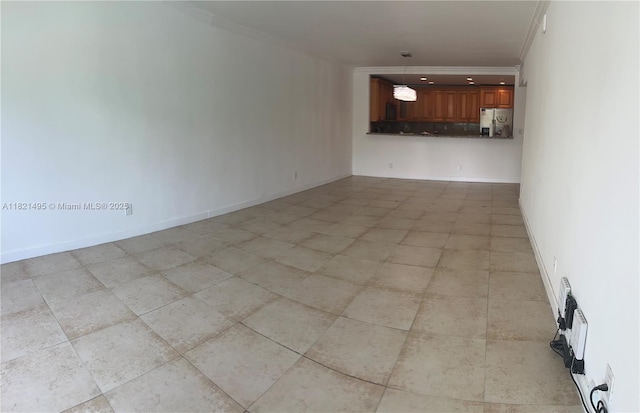 19390 Collins Ave Unit 207, Sunny Isles Beach, FL 33160 - unfurnished living room featuring crown molding and light tile patterned flooring