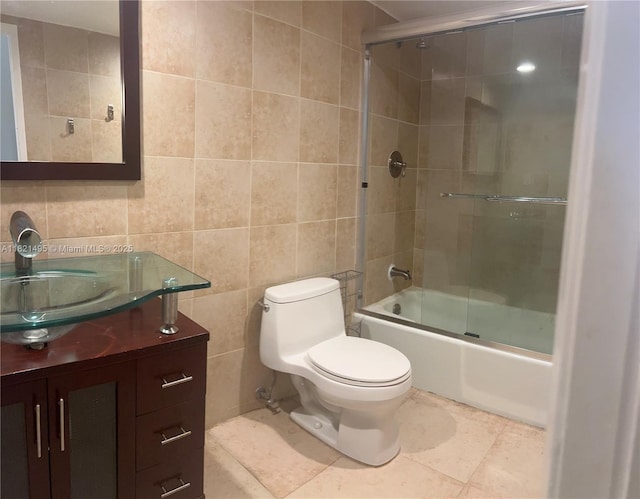 19390 Collins Ave Unit 207, Sunny Isles Beach, FL 33160 - bathroom featuring tile walls, vanity, combined bath / shower with glass door, and tile patterned flooring